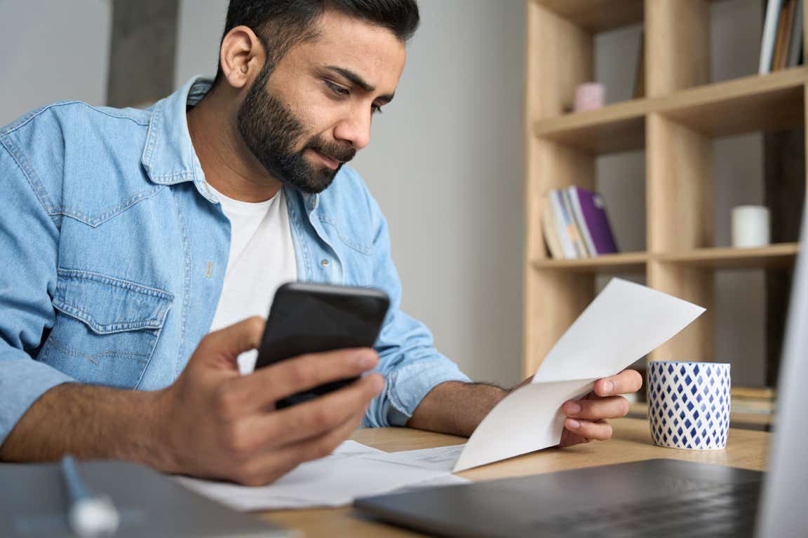 worried man with phone bill