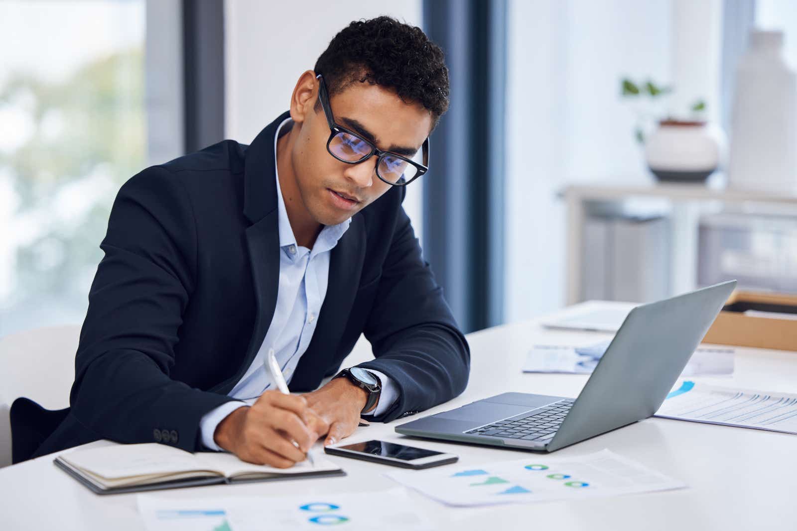 A businessman on a laptop reviewing company finances.