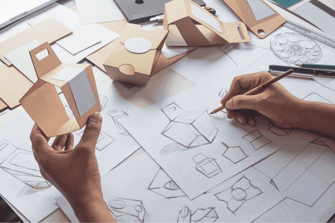 Designer sketching drawing design Brown craft cardboard paper product eco packaging mockup box development template package branding Label