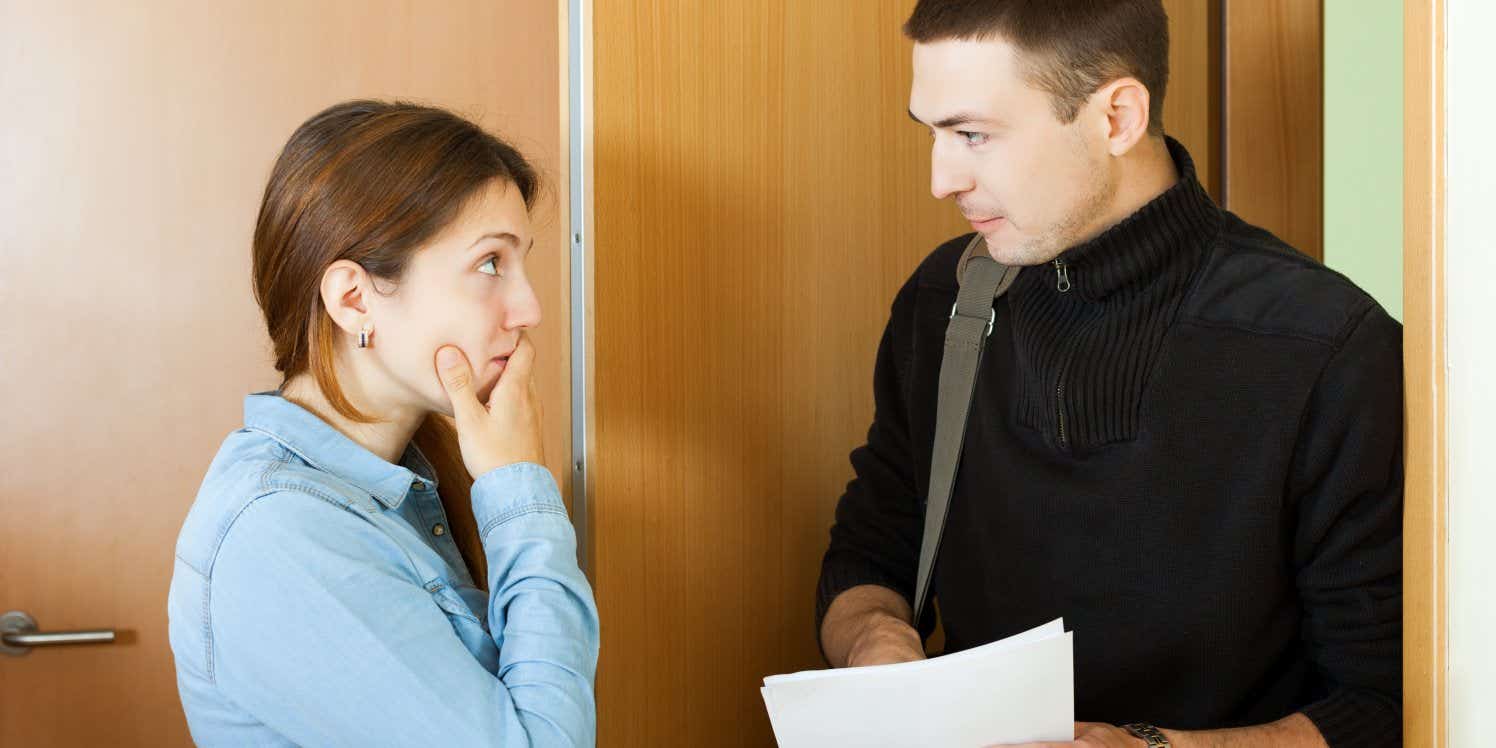 Debt collector talking to woman