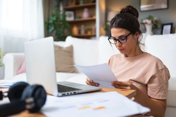 Businesswoman working on her tax returns at home.
