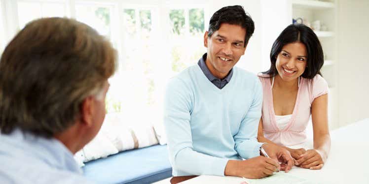 couple-discussing-finances-with-advisor