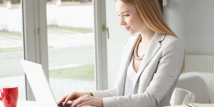woman-at-desk-with-laptop-calculator-and-documents