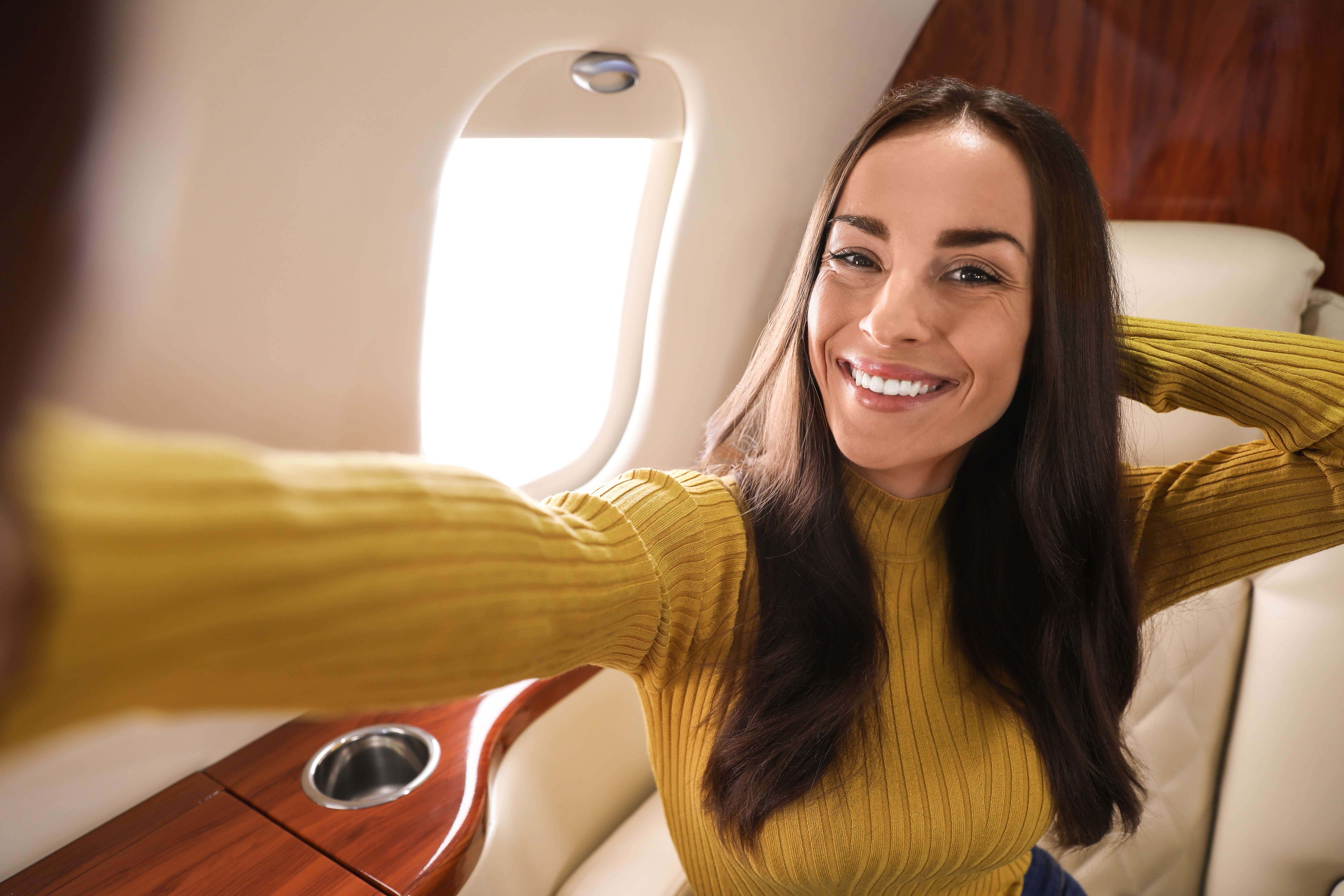 A woman sitting in first class on a plane