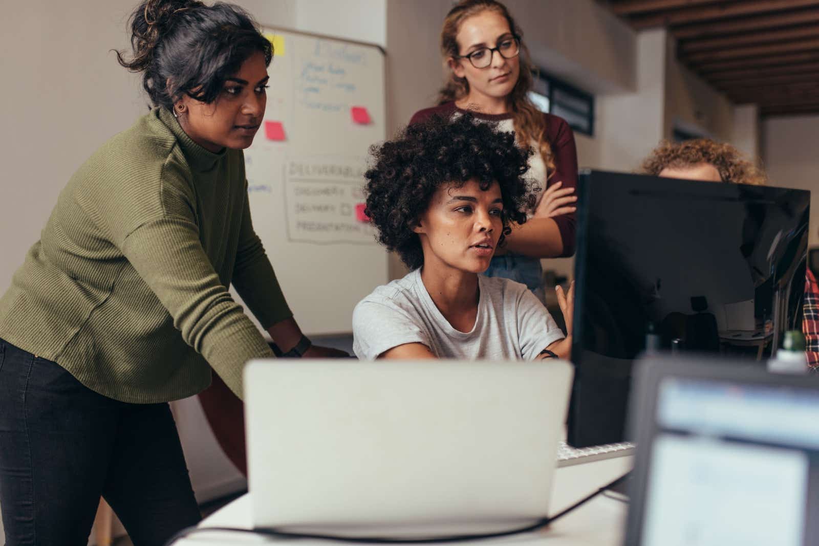 Group of young women working on a digital project.