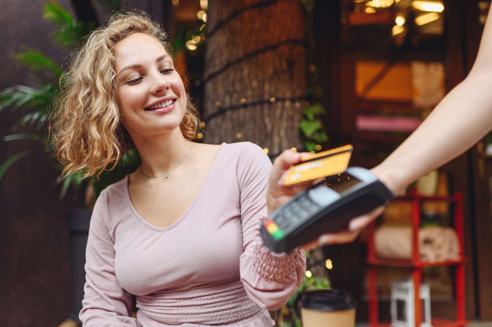 A customer paying with their phone in a shop