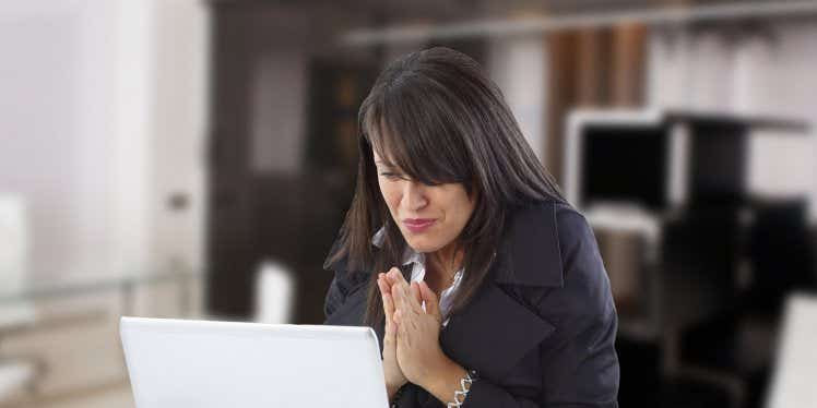 woman-holding-hands-together-on-laptop