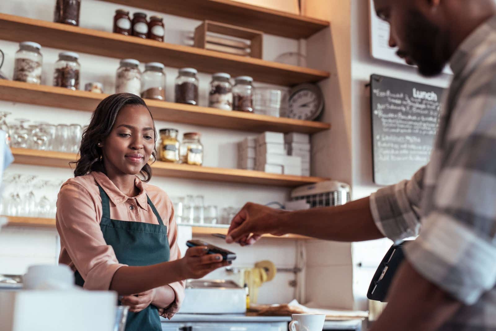 Deli owner taking a credit card payment.