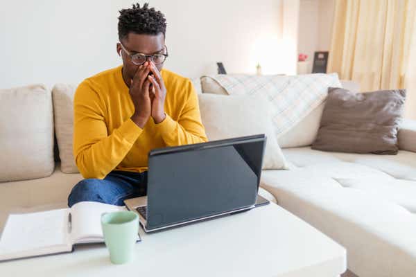 Man shocked at something he has seen on his laptop's screen