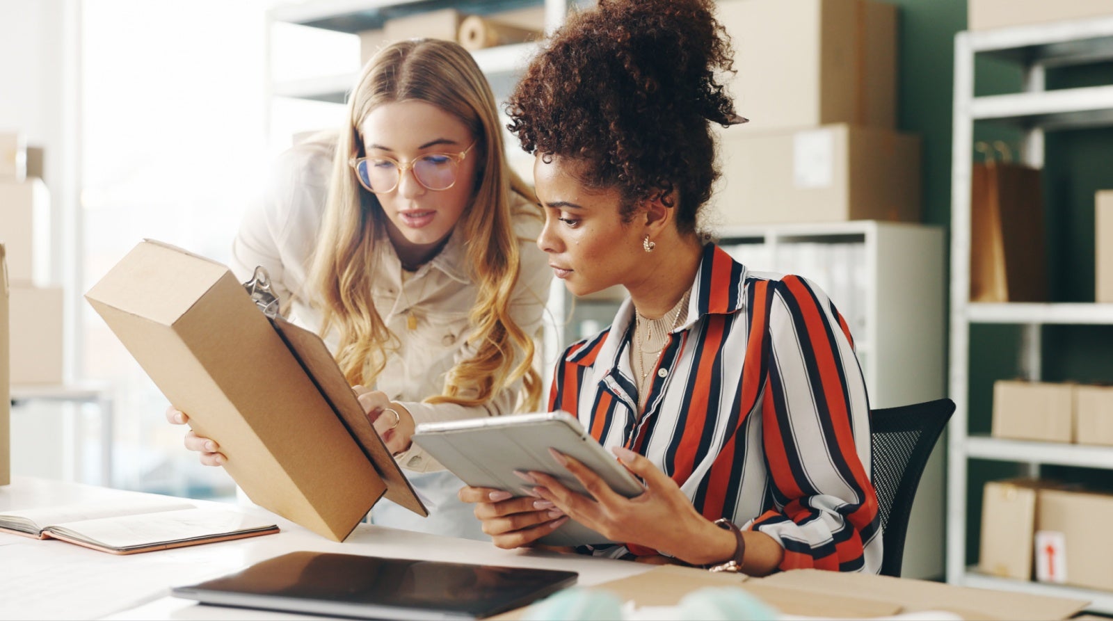  Two colleagues look at packaging for their small business