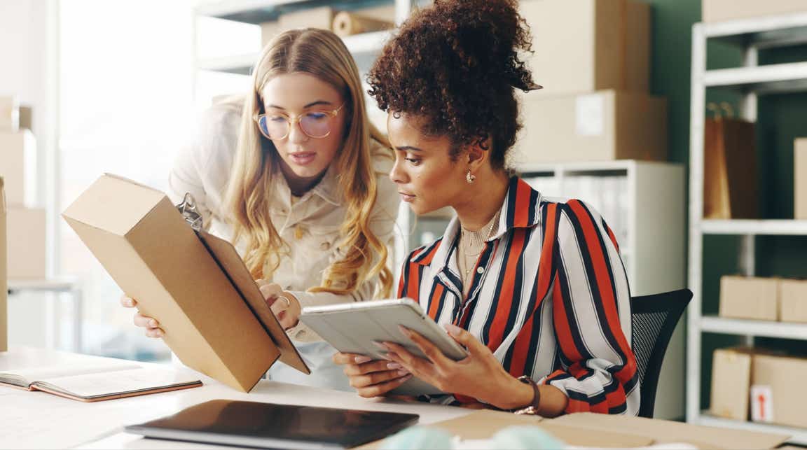  Two colleagues look at packaging for their small business
