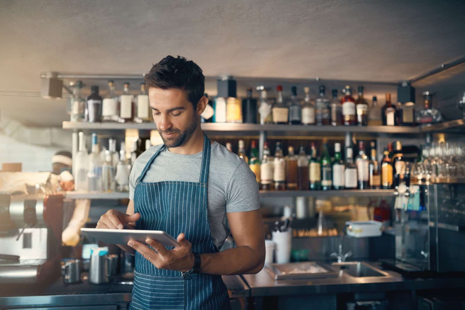 Man in a bar working on his tablet