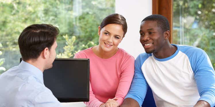 couple-looking-at-paperwork-with-financial-advisor