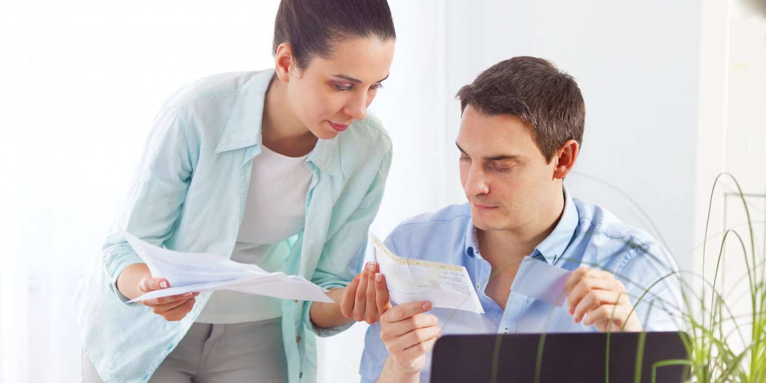 Couple comparing paperwork