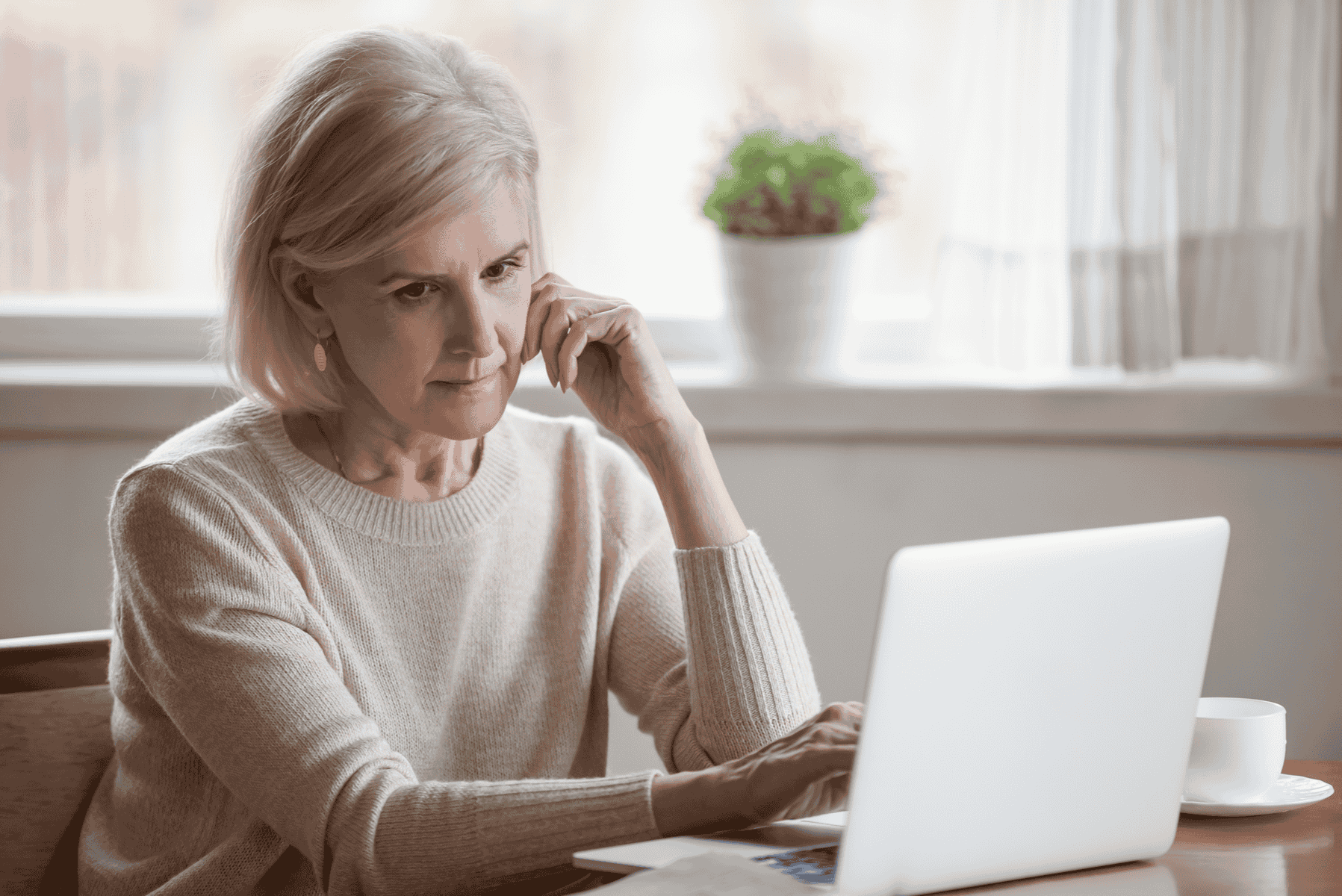 Worried woman looking at laptop