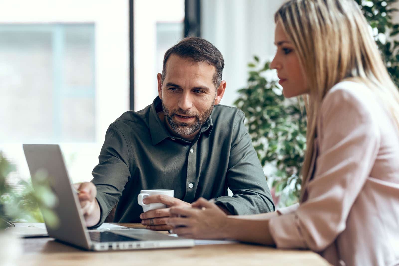 Two colleagues working together on a laptop