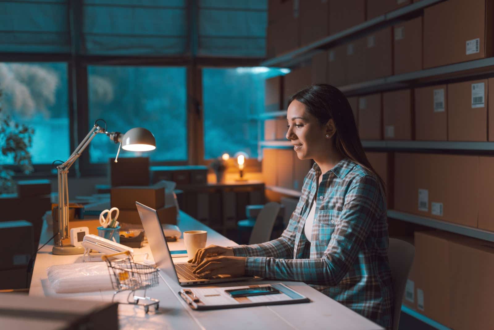 Woman working late at night at her drop-shipping business.