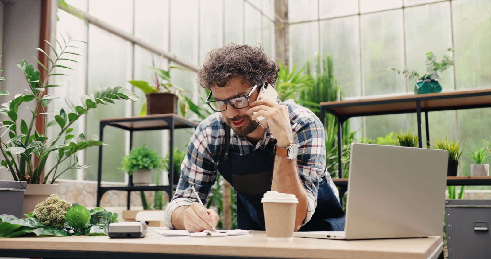 Owner of a plant shipping business on the phone. 