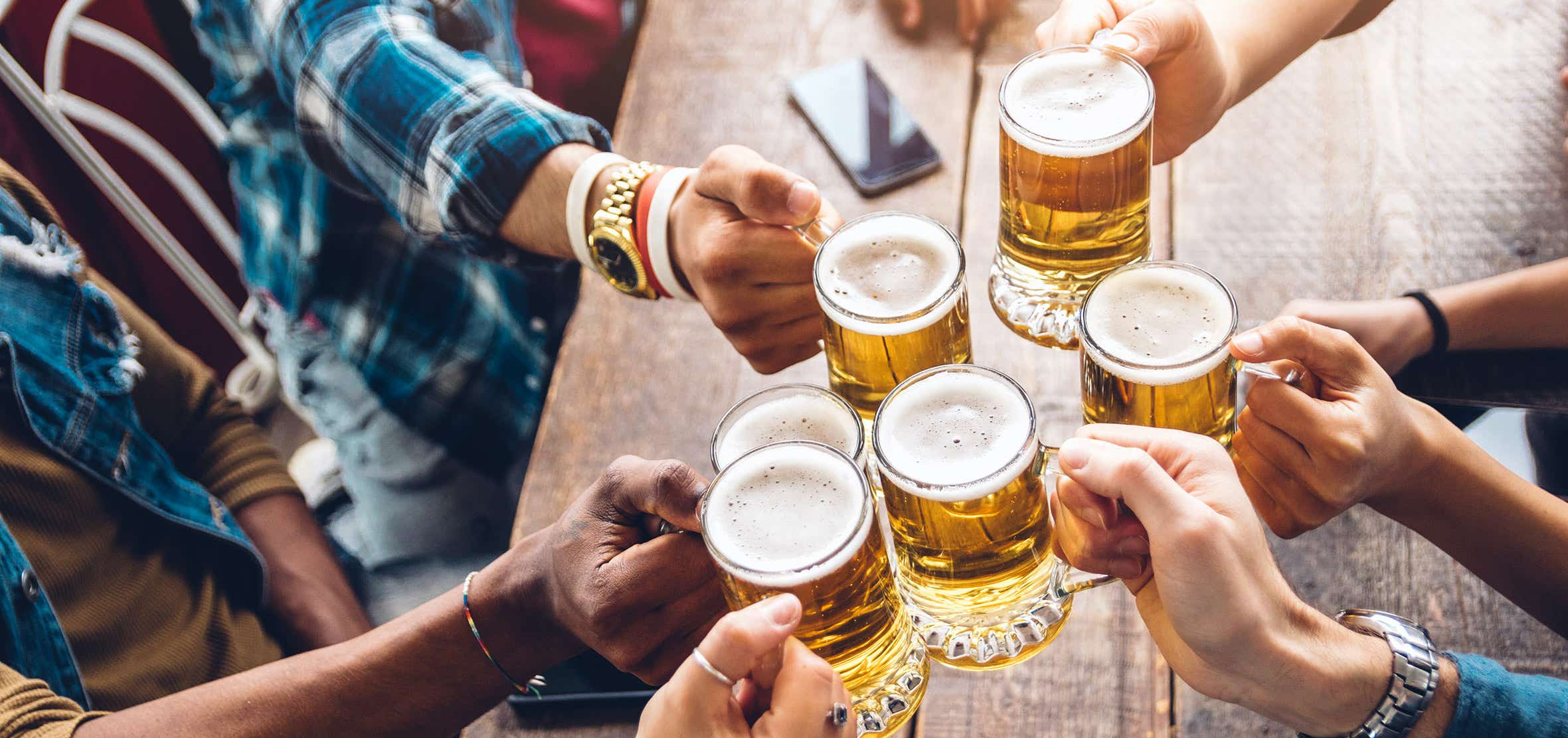 A photo of people with pint glasses.