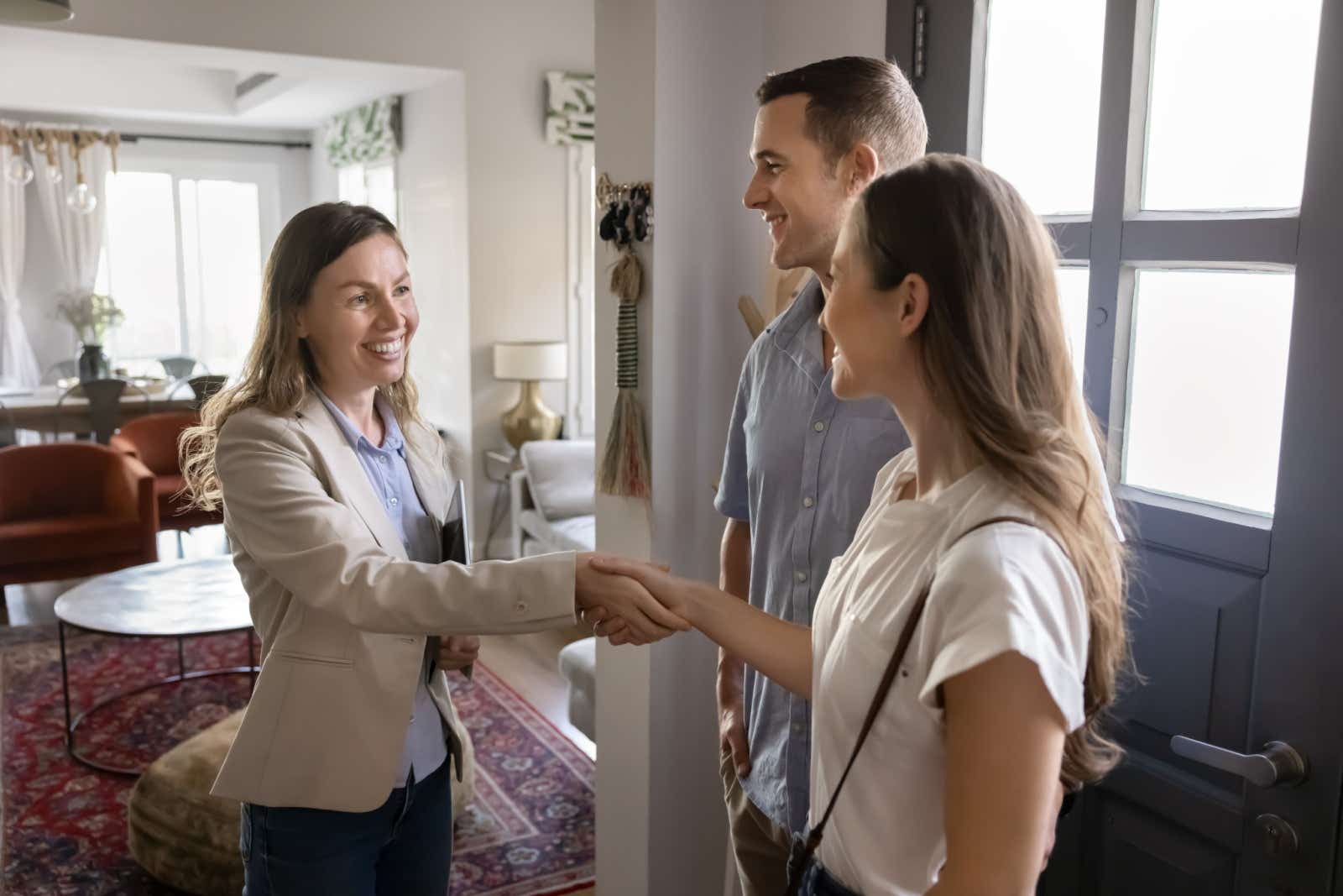 Landlord greeting potential new clients inside the door of a property