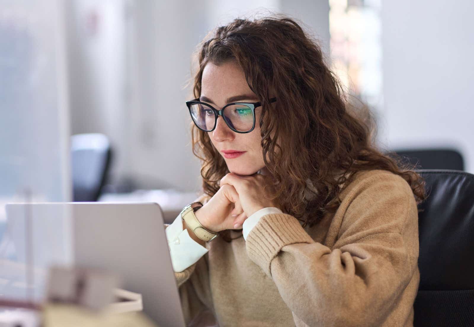 Woman stares at her laptop screen