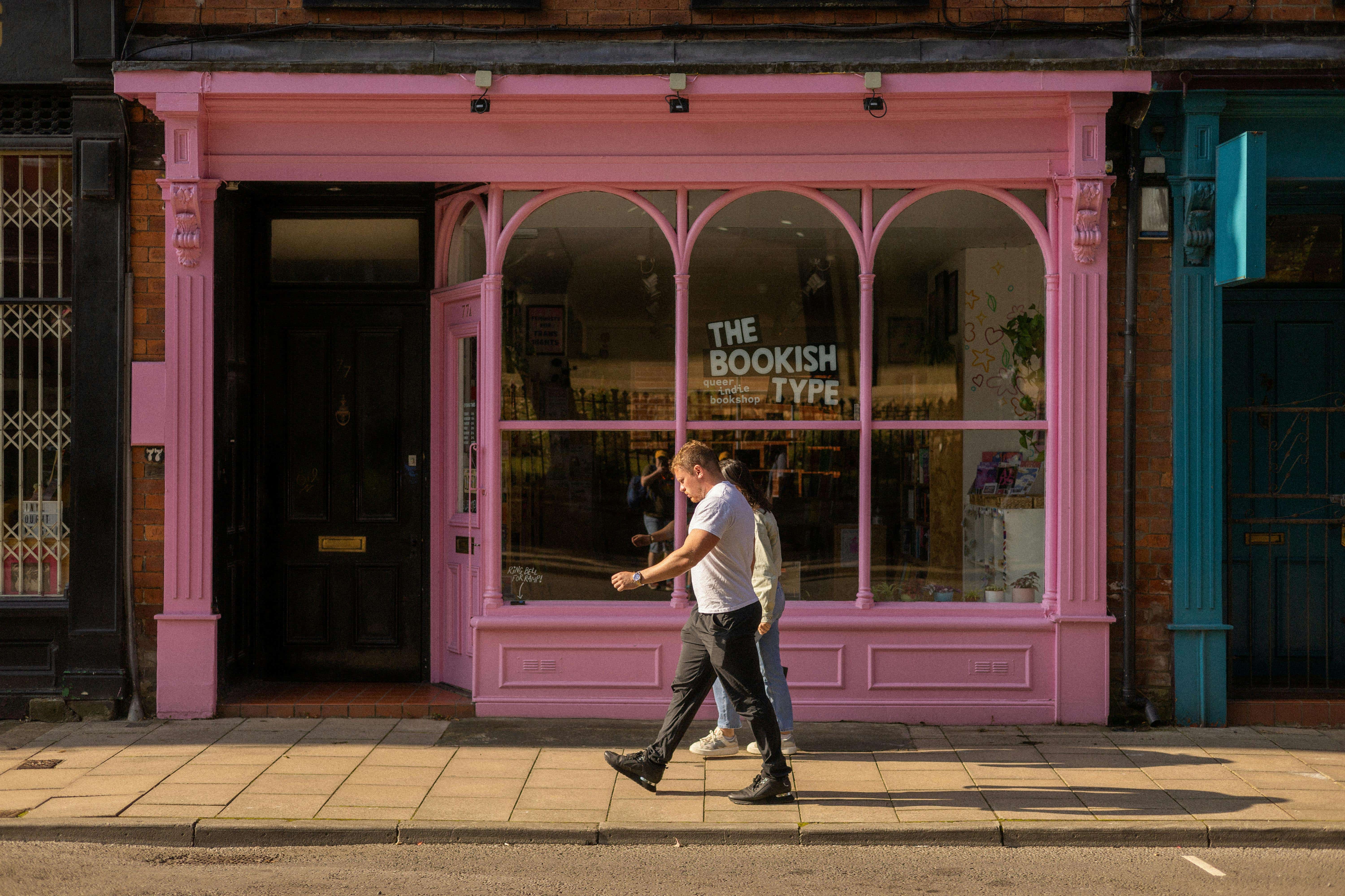 A man walks along a shopping street