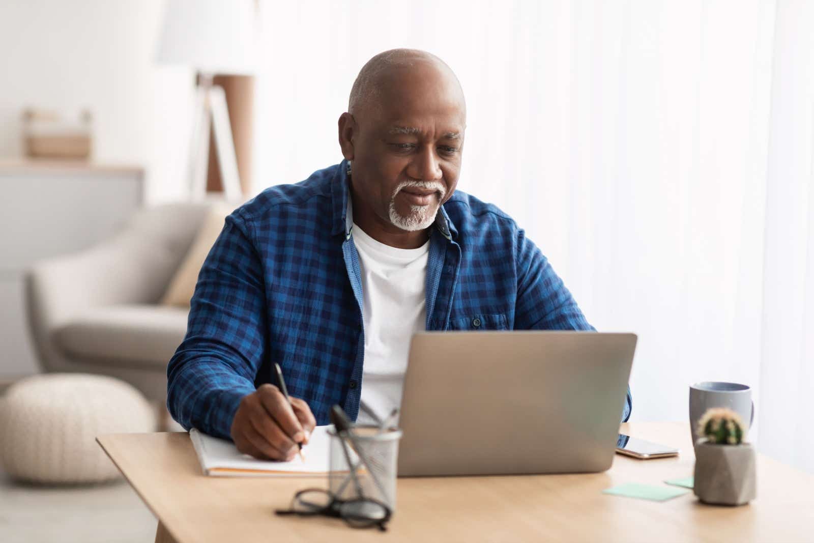 Older businessman working from home on his laptop.