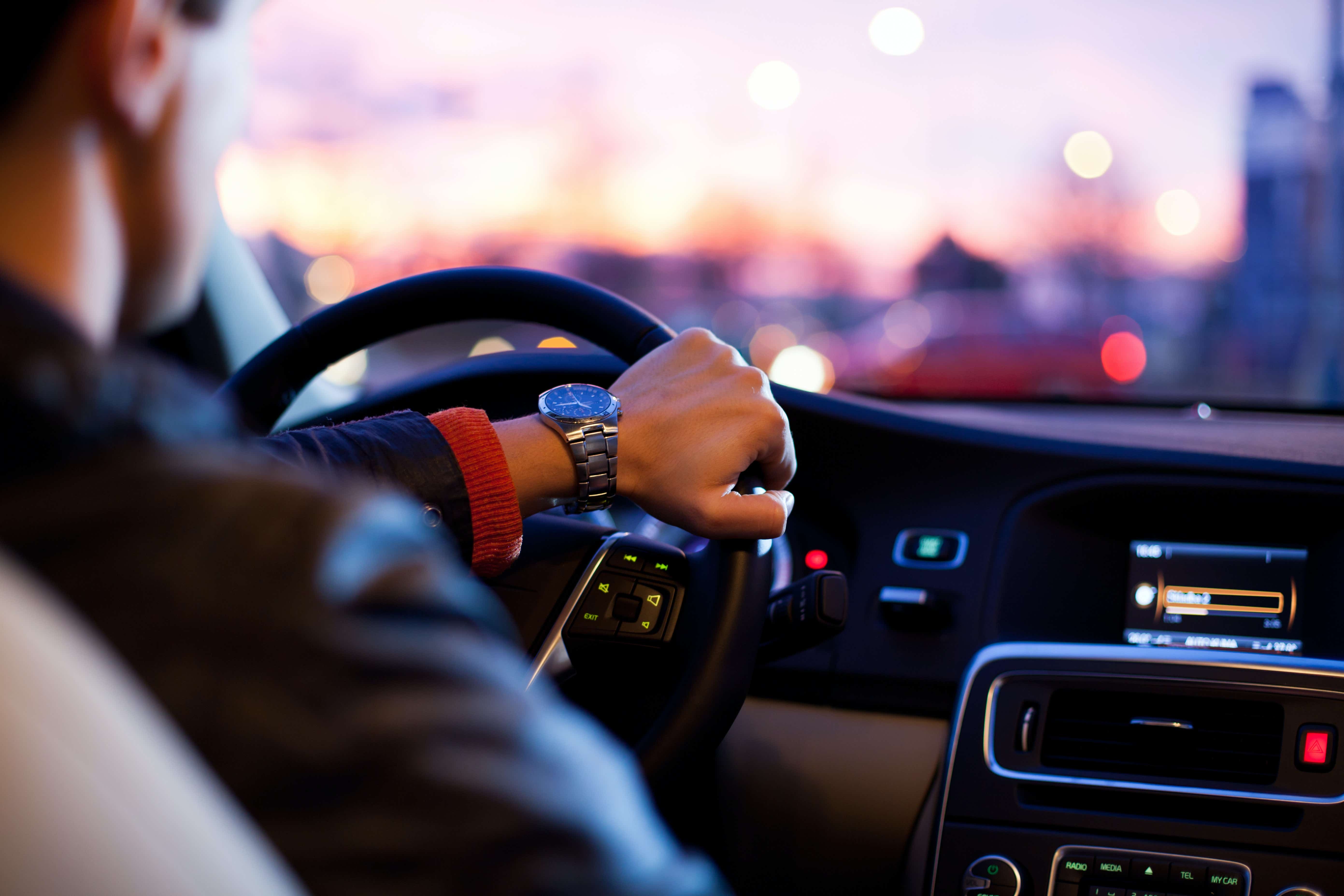 Man driving a car at night time 