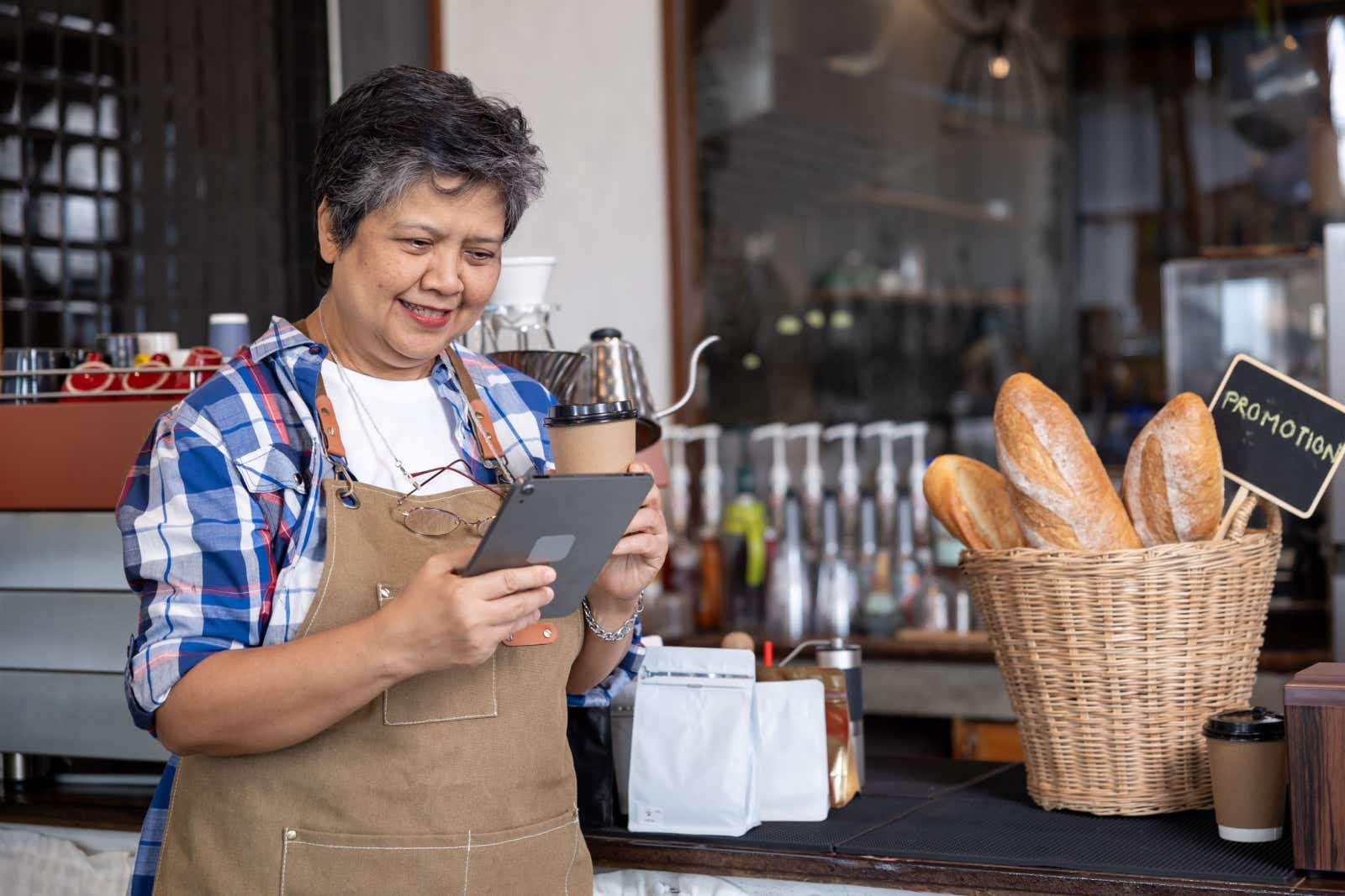 Bakery owner checks her tablet.