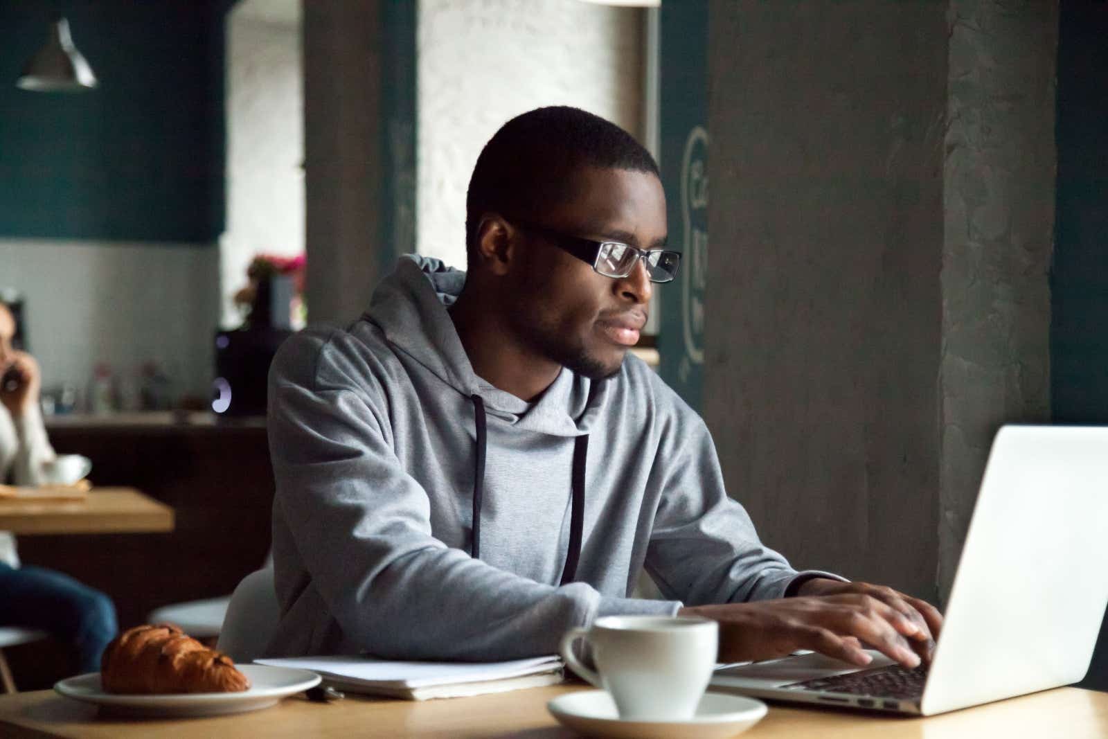 Man working on his laptop in a cafe.