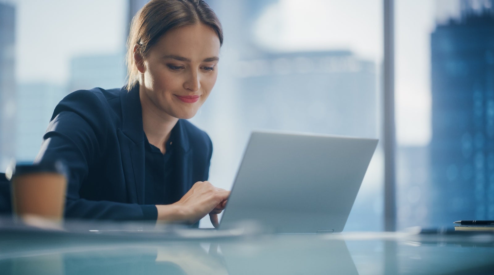 Young businesswoman working on her laptop in an office.
