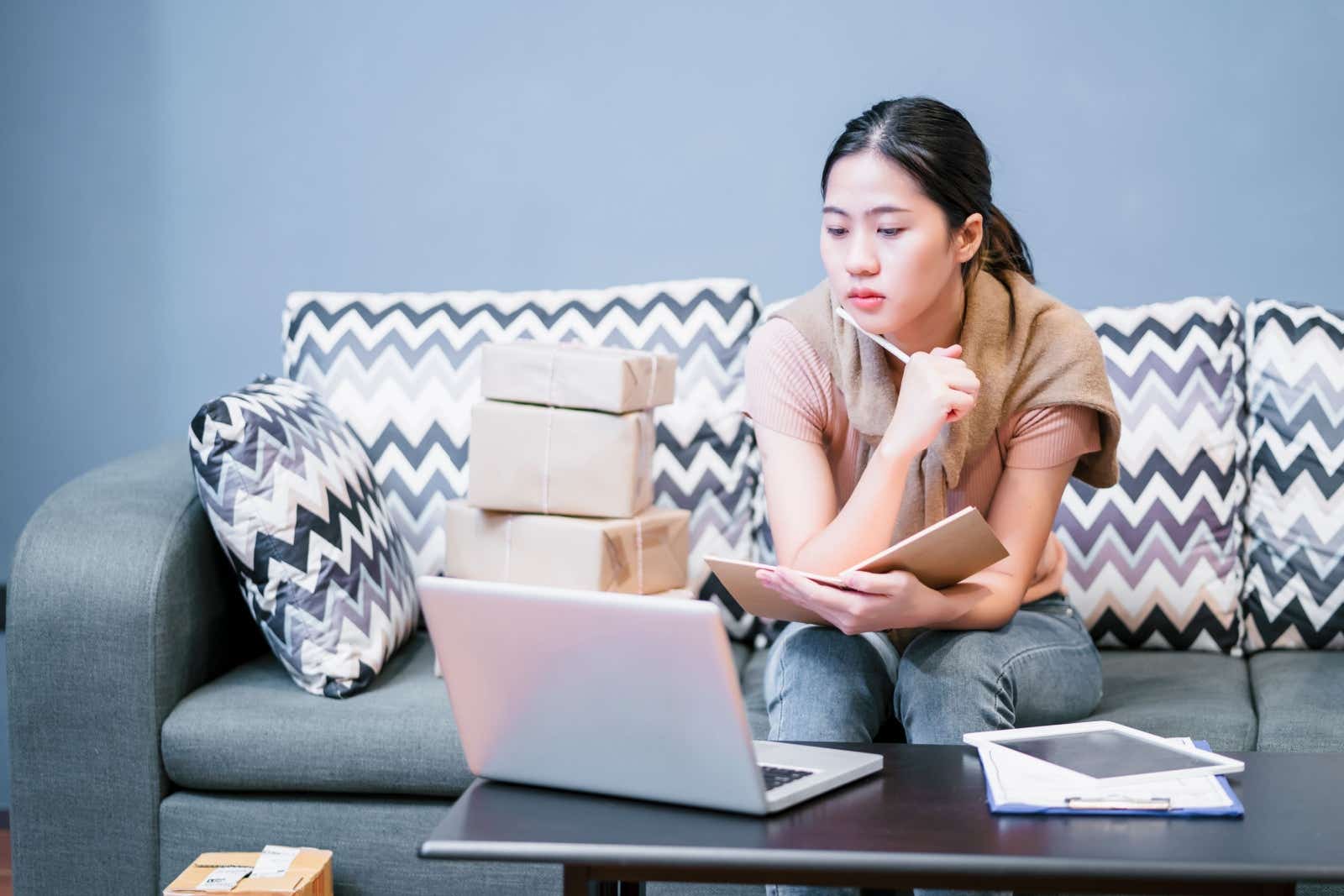 Thoughtful business woman doing paperwork from home. 