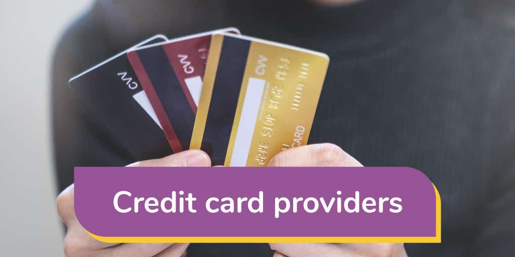 man holding three different credit cards 