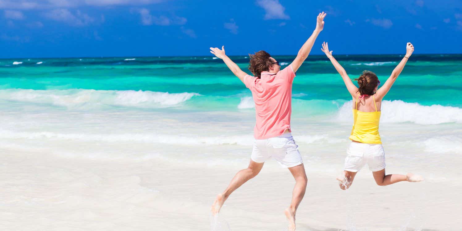 Couple on beach jumping