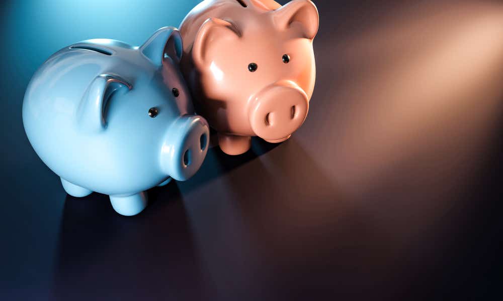 Two piggy banks side by side, one is blue and the other is pink. 