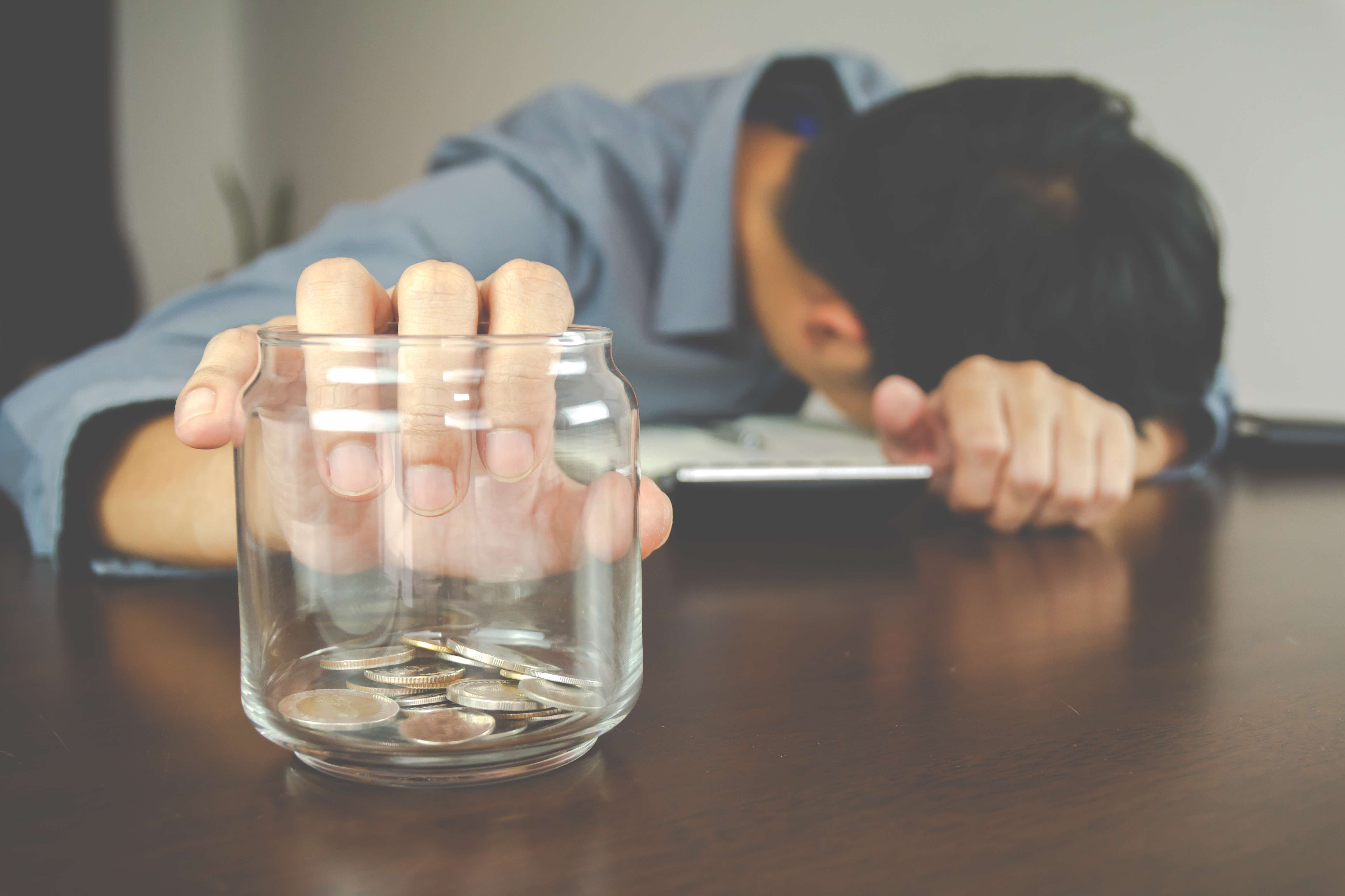 A man reaches into his savings to withdraw money