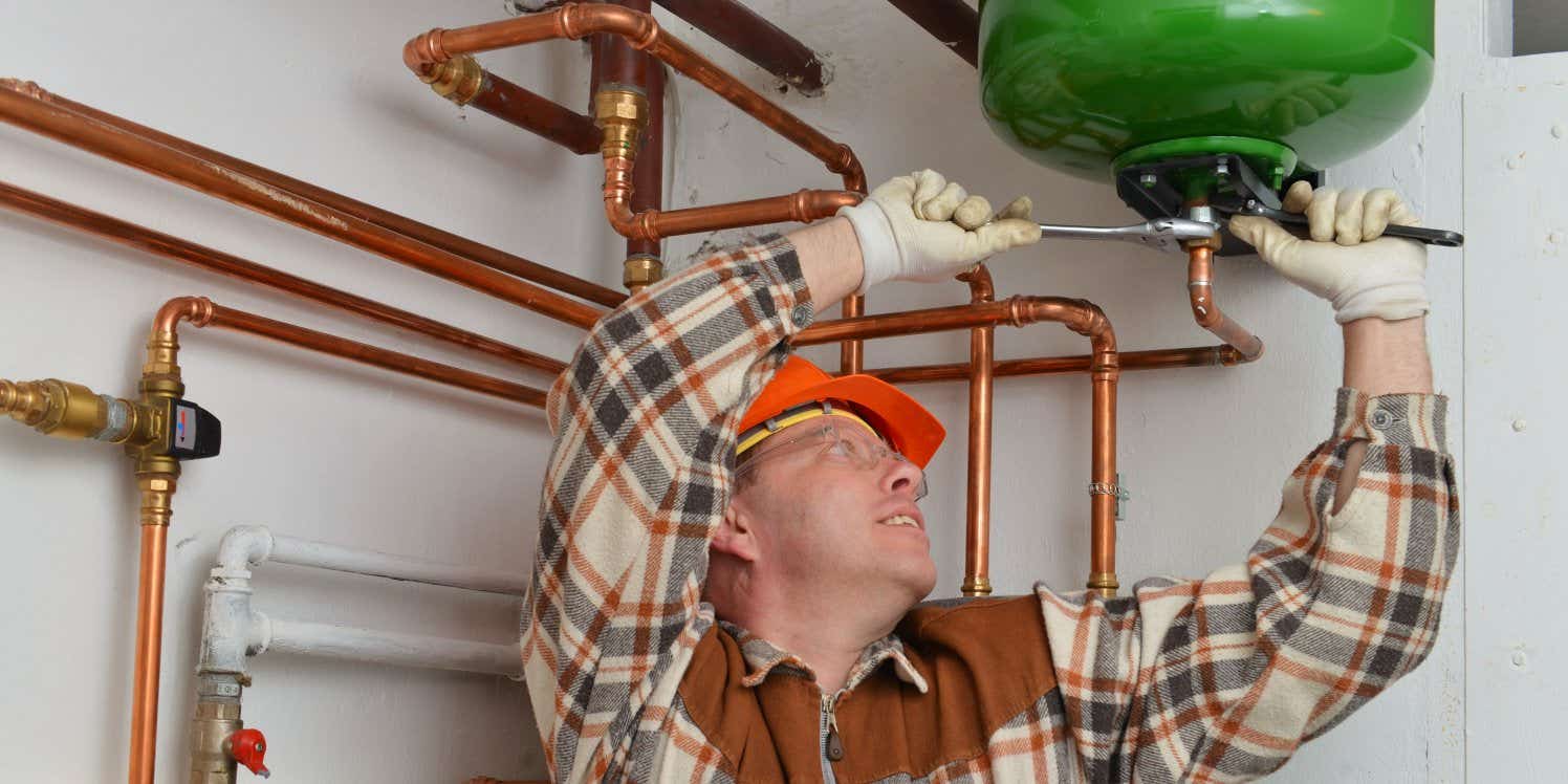 Plumber fixing boiler