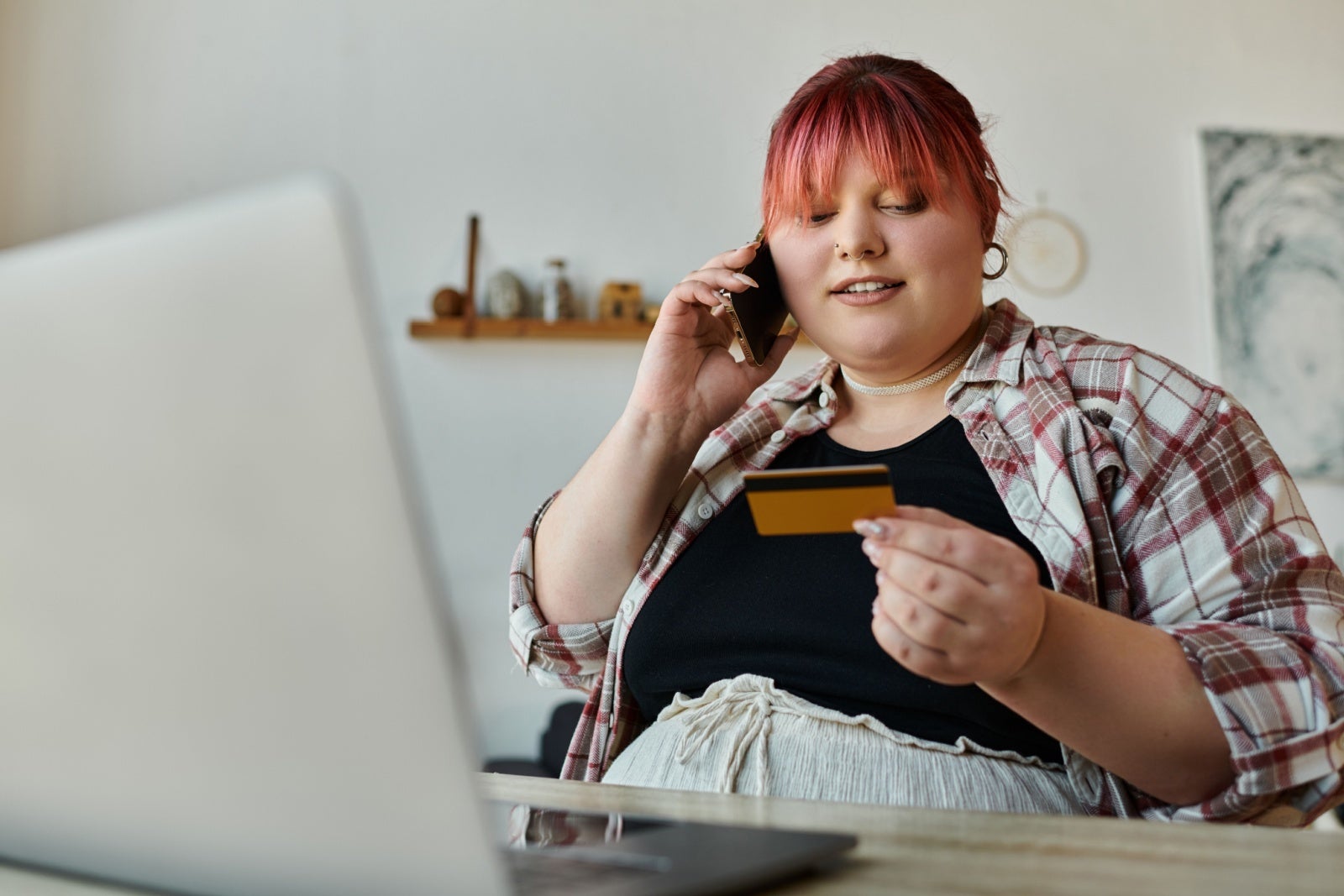 Woman paying for something by credit card on the phone