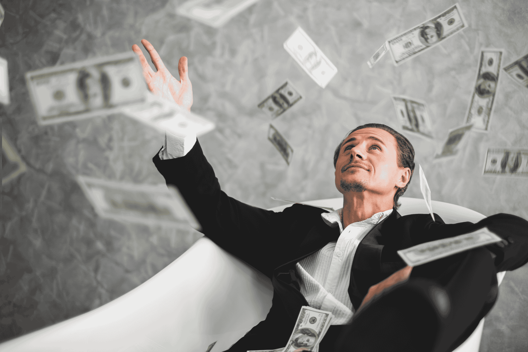 Fully-dressed man in an empty bath with money raining down on him