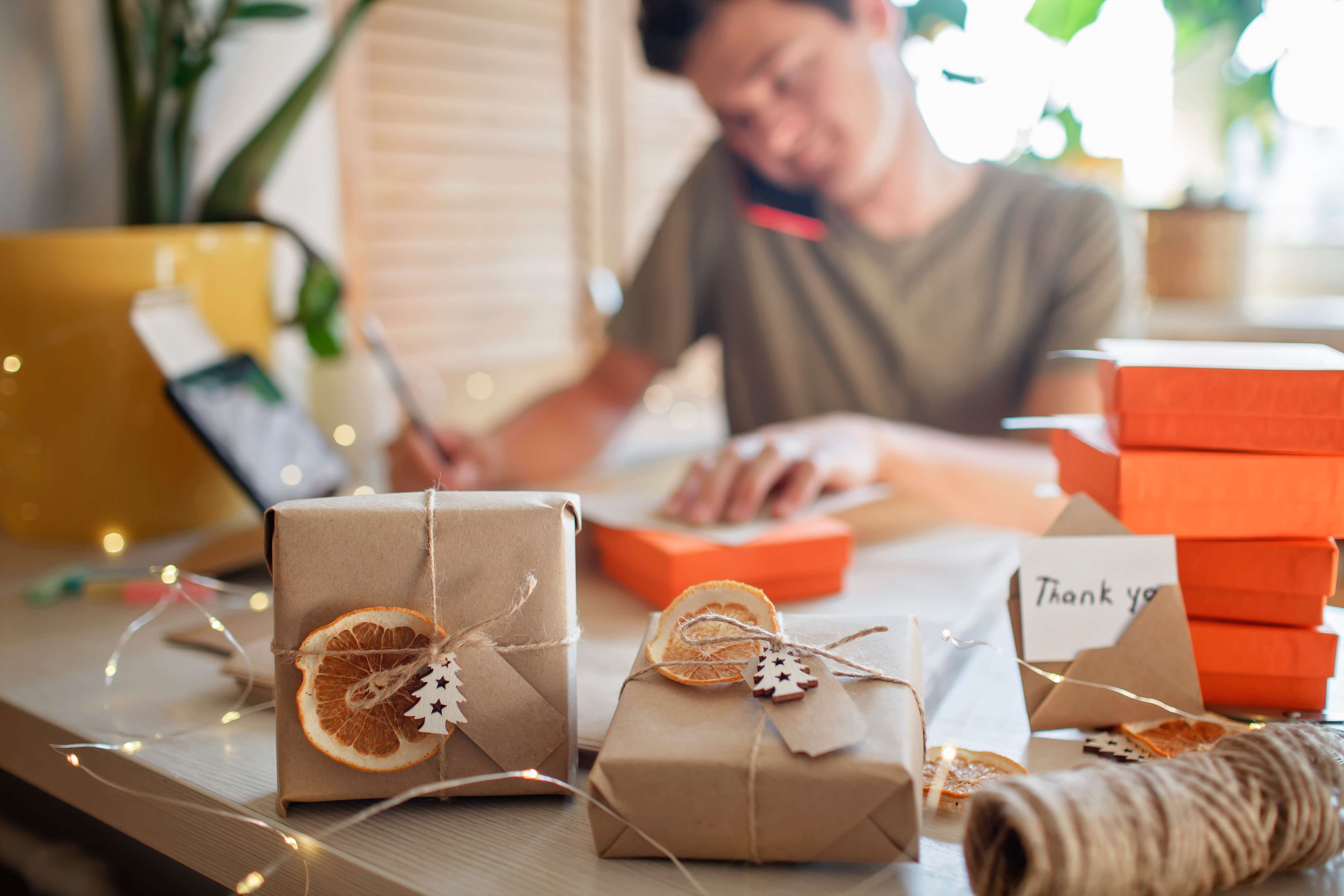 A business owner on the phone in a festive workplace