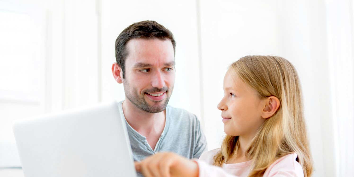 man-daughter-laptop-table-home