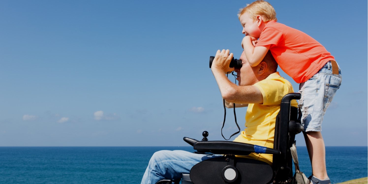 father son looking out to sea