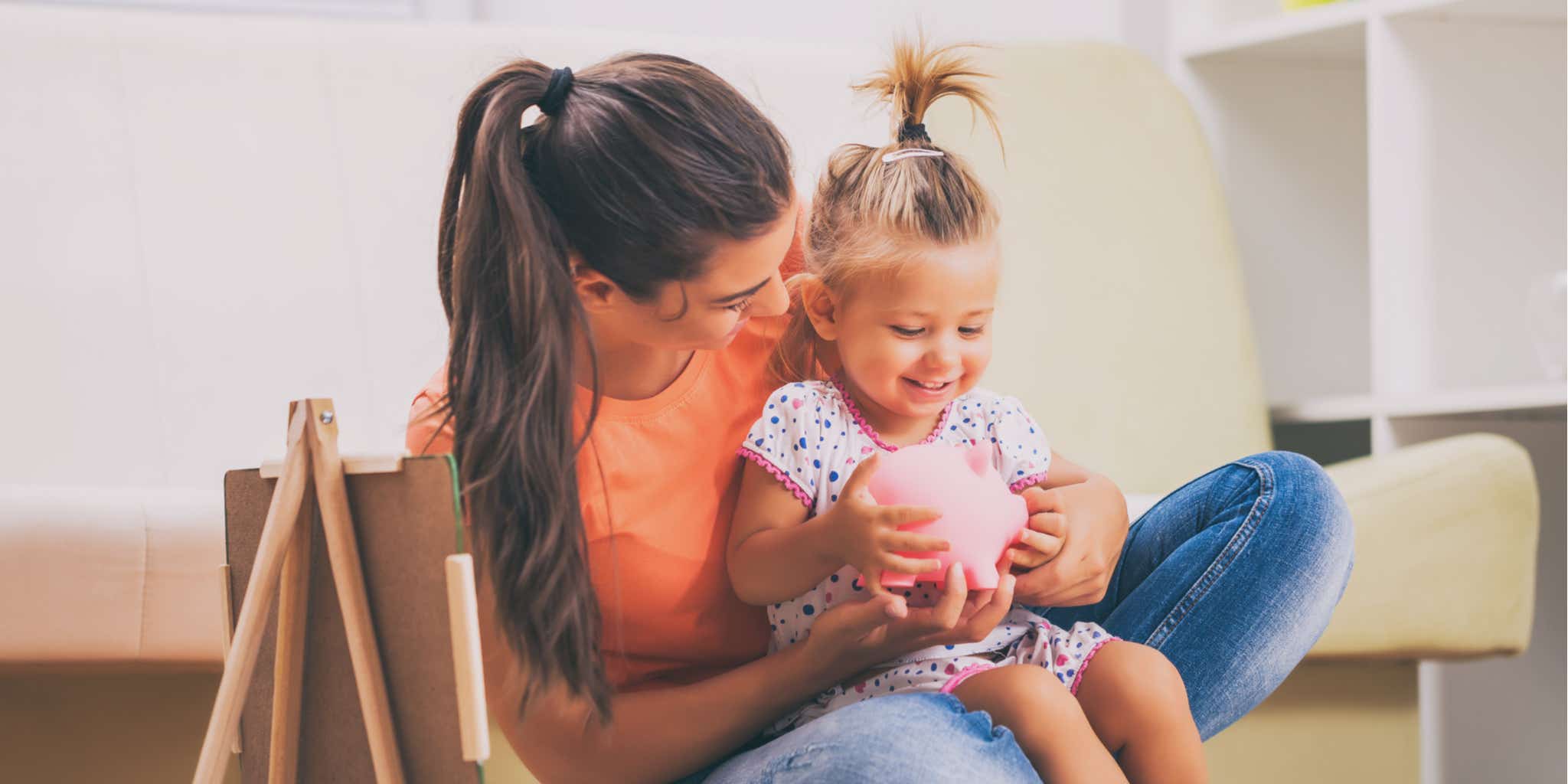 Mother teaching daughter how to save