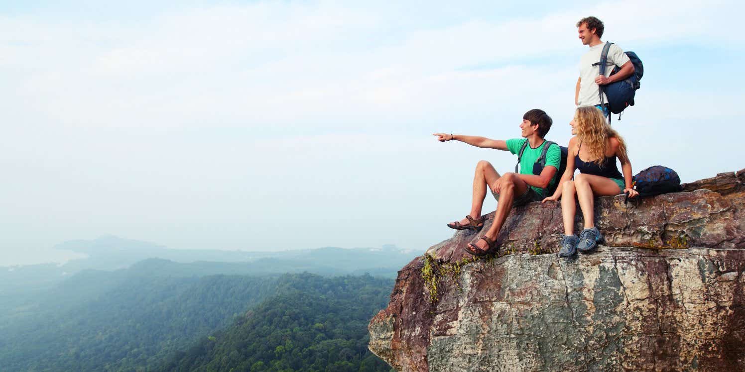 three travellers standing on a cliff