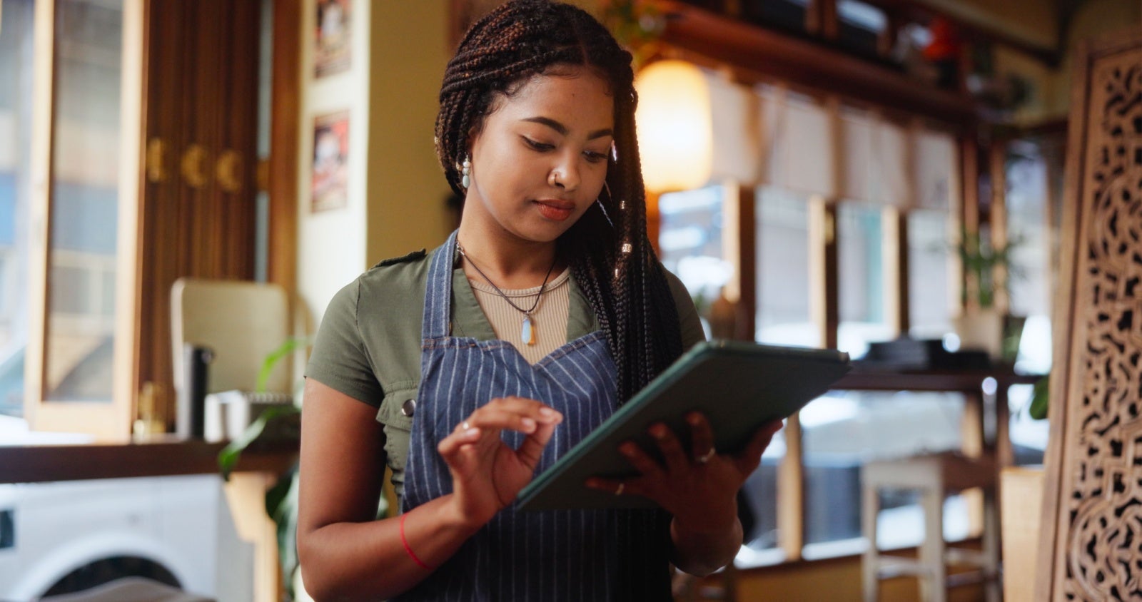 Cafe owner works on her tablet