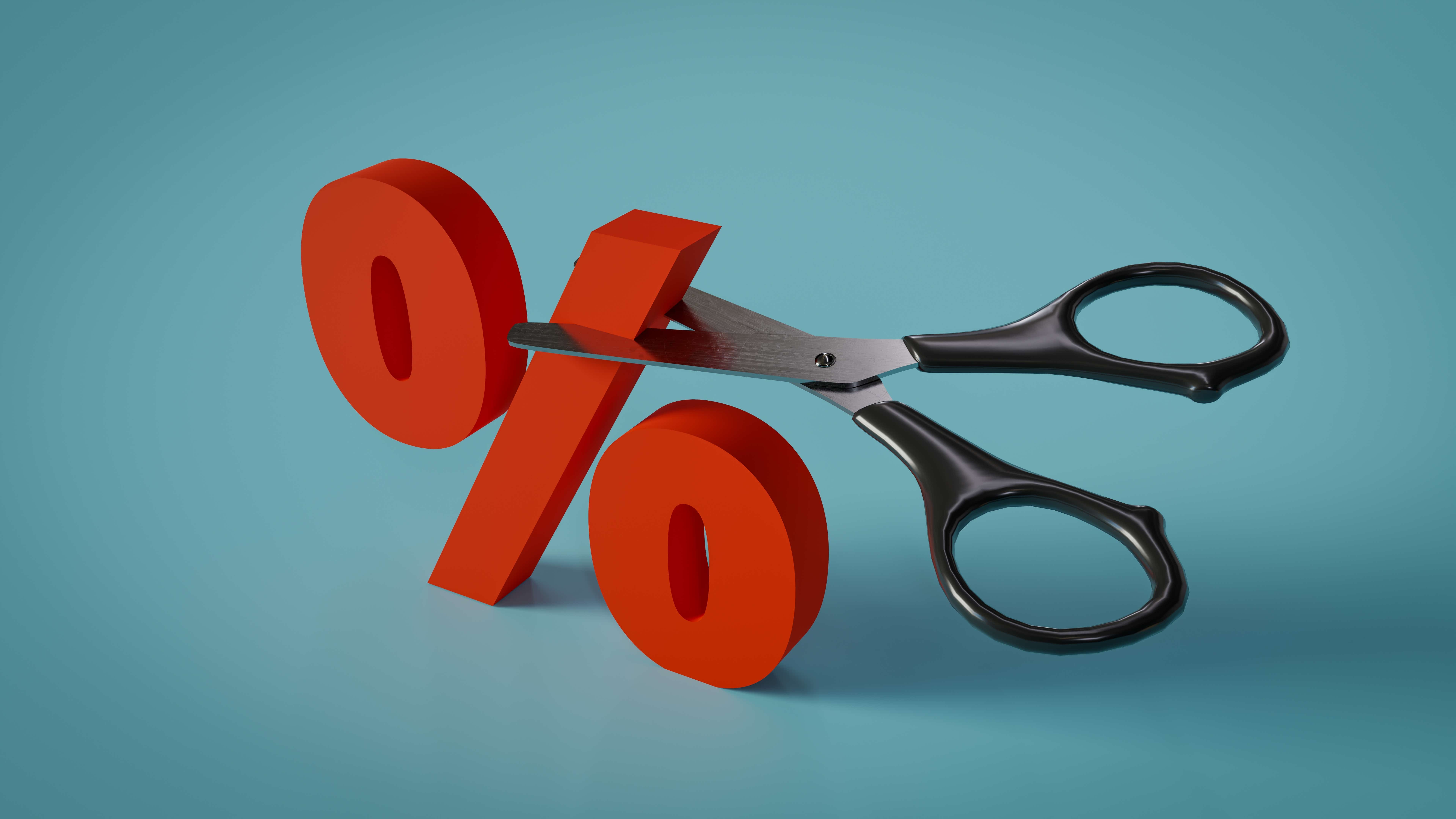 Percentage symbol with a pair of scissors to highlight interest rates cut