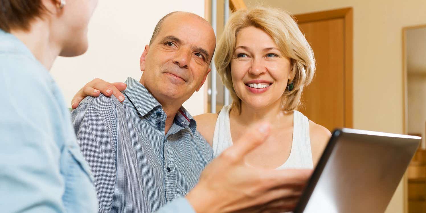 older couple with advisor on laptop