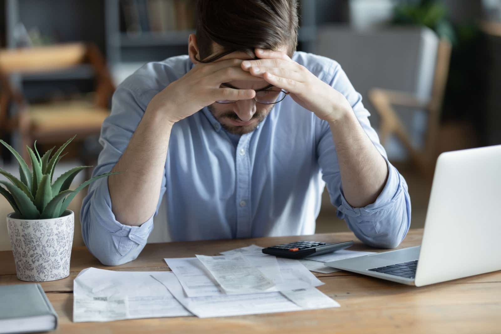 Worried businessman looking at bills