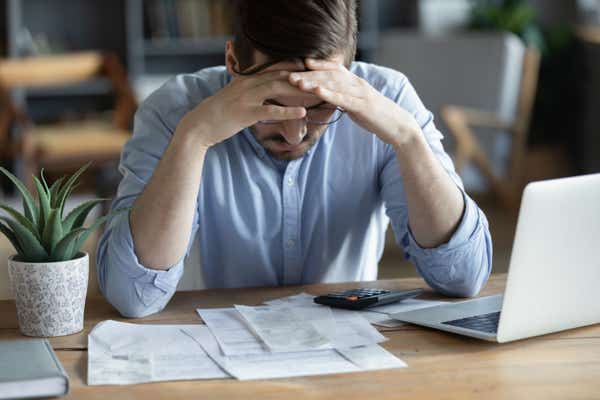 Worried businessman looking at bills