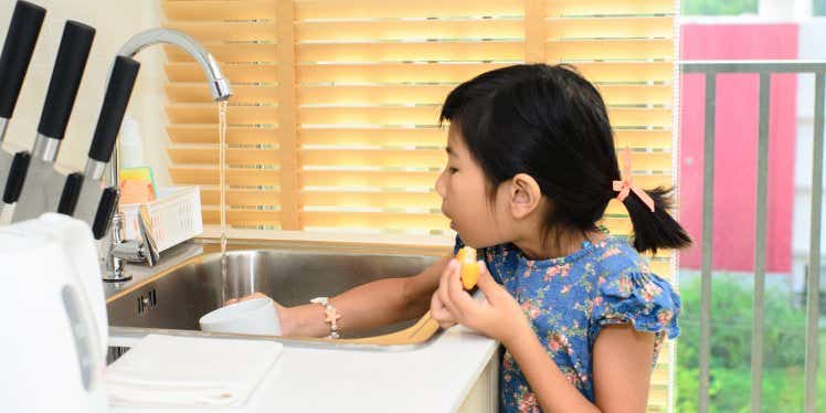 girl-pouring-water-into-a-cup